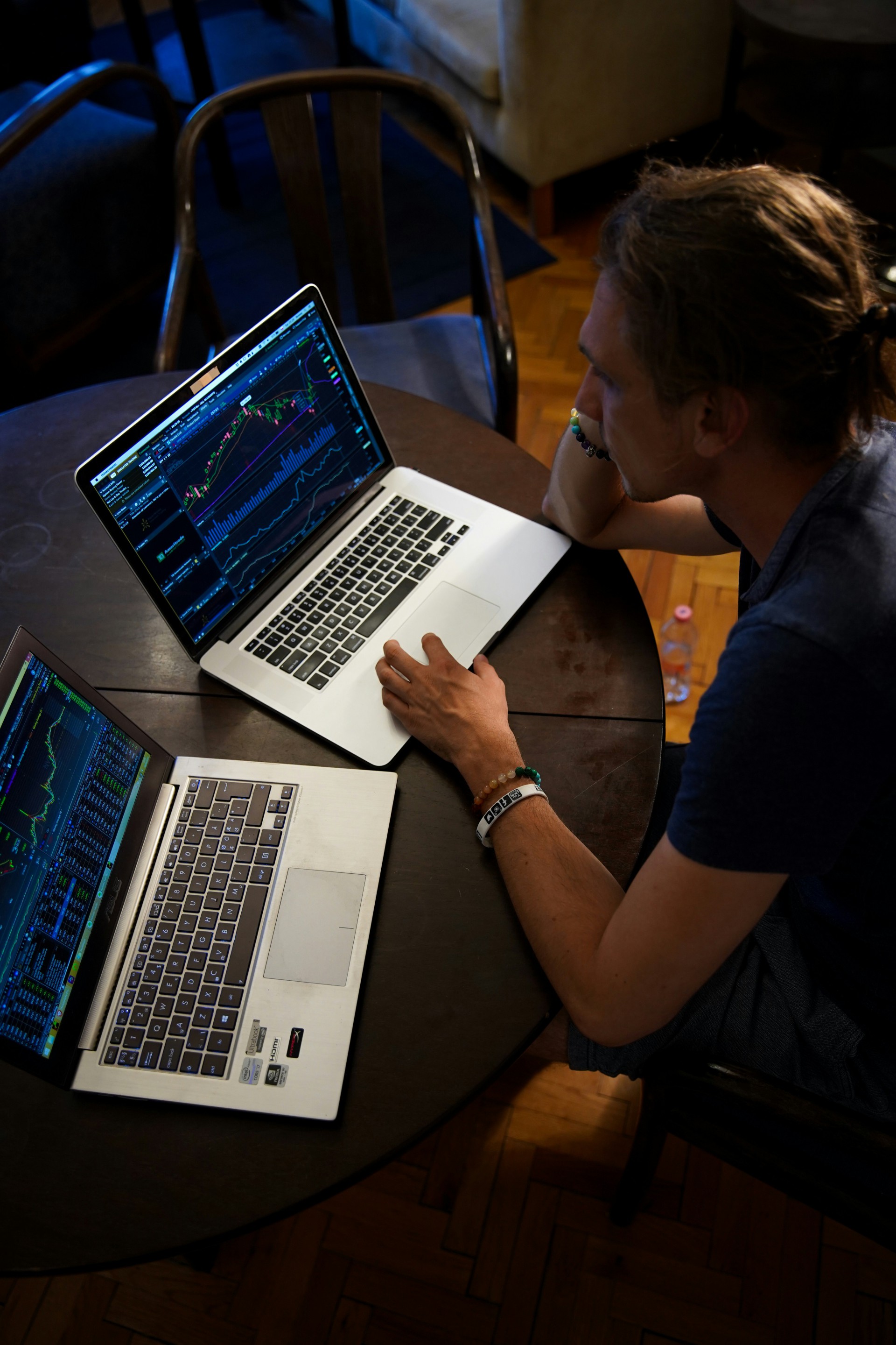 man sitting in front of the macbook pro