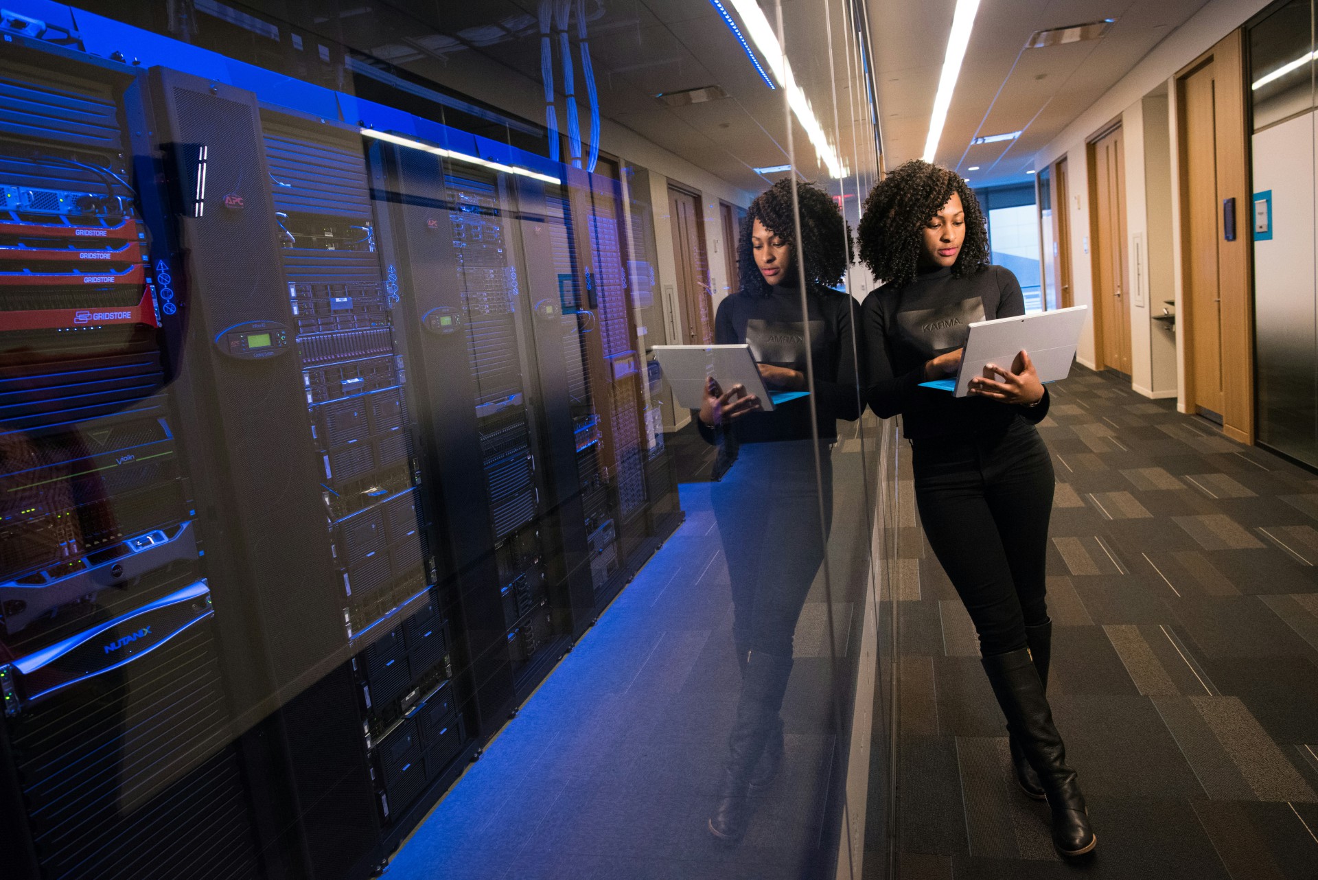 woman in black top using surface laptop